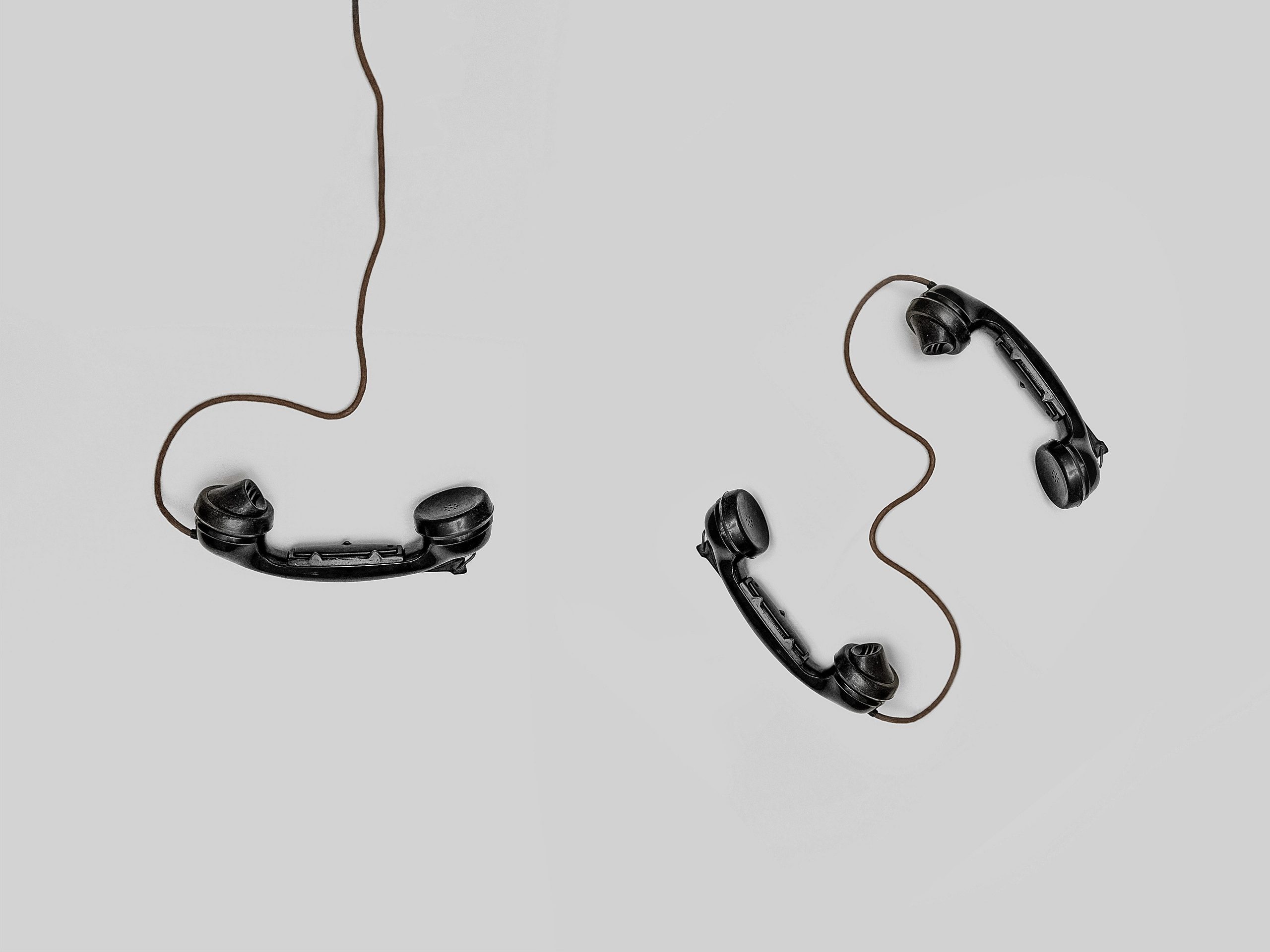 Three telephones with leads attached
